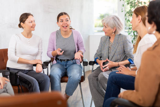 Young female teacher giving lecture to group of students in classroom Drug Rehab