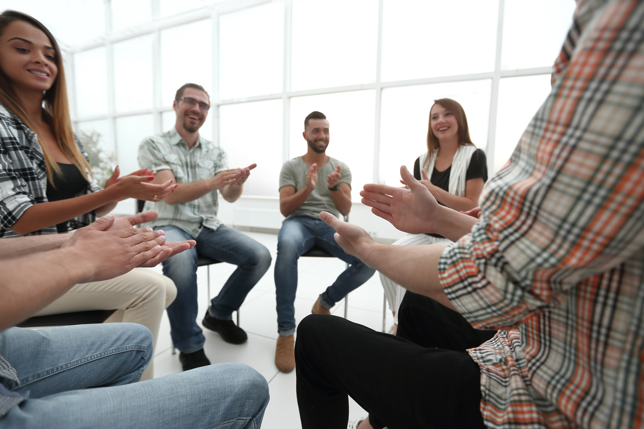 business team applauds at a workshop Transforming Lives from Despair to Hope in Hanover, MA